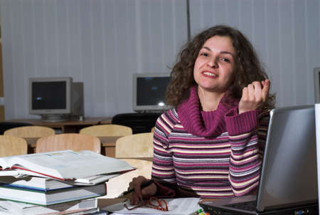 Young female student is studying in classroom.の写真素材