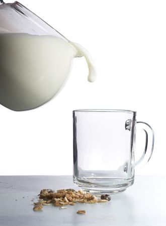 Isolated. Breakfast preapring using milk, muesli and corn flakesの写真素材