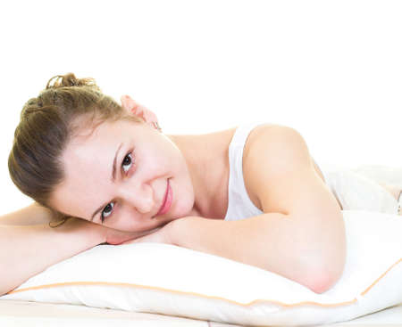 Young girl is relaxing in the bed. Isolated.の写真素材