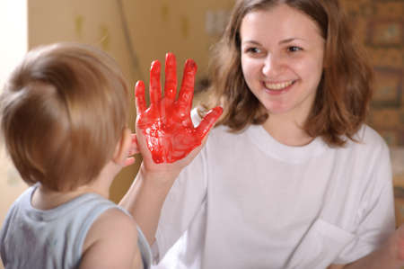 Young mother is playing with her little sonの写真素材