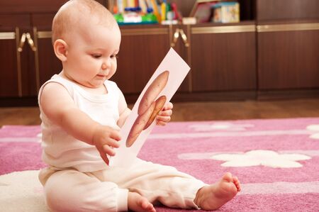 Cute baby playing wth cards and study vegetables