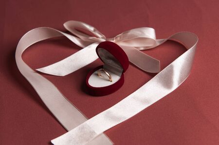 Ribbon heart shape on textile background