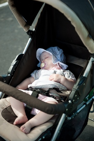 Little baby girl is sleeping in strollerの写真素材