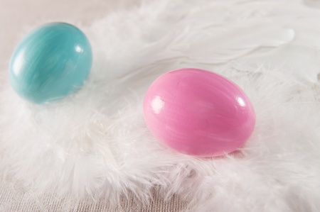 Colorfull vibrant Easter eggs on feather background