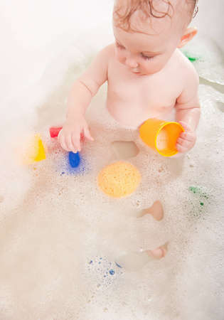 Little baby girl having soapy bath at home