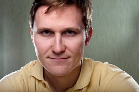 Portrait of a young man over green wallの写真素材