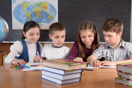 Group of pupils aged 11 study at classroomの写真素材