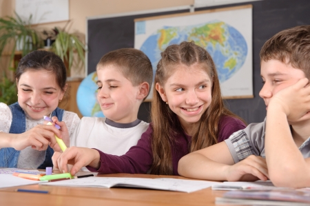 Group of pupils aged 11 study at classroomの写真素材