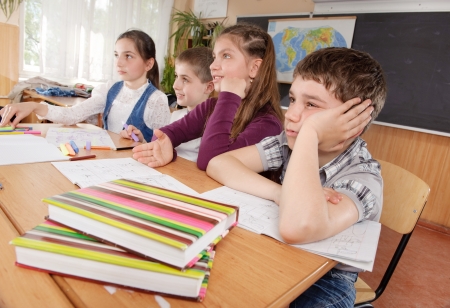 Group of schoolchildren at classroom during a lessonの写真素材