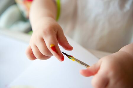 Little baby painting on white paper. Closeup viewの写真素材
