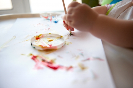 Little baby painting on white paper. Closeup viewの写真素材