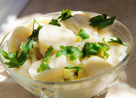 Russian pelmeni in dish with green parsleyの写真素材