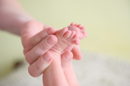 Close-up of newborn baby's feet in mothers handの写真素材