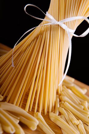 A bunch of long spaghetti pasta over dark backgroundの写真素材