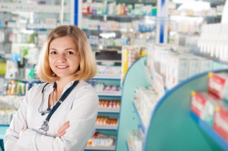 Young pharmacist with phonendoscope in drugstoreの写真素材