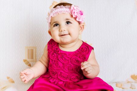 Cute baby girl in pink floral dressの写真素材