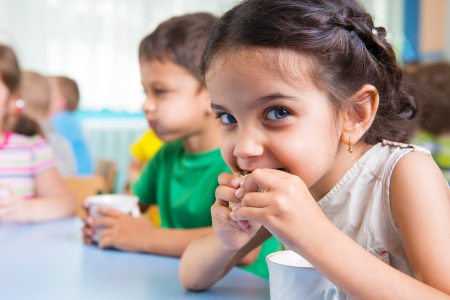 Cute little children drinking milk at daycare Cute little children drinking milk at daycare