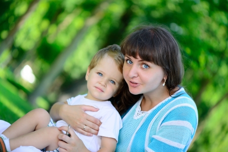 Happy young mother with her son in parkの写真素材