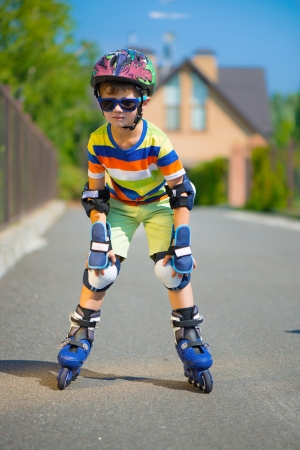 Cute little boy in sunglasses with rollersの写真素材