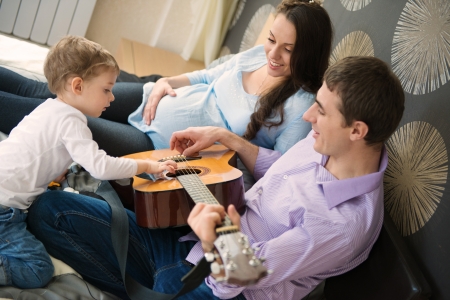 Happy young family portrait in modern apartmentsの写真素材