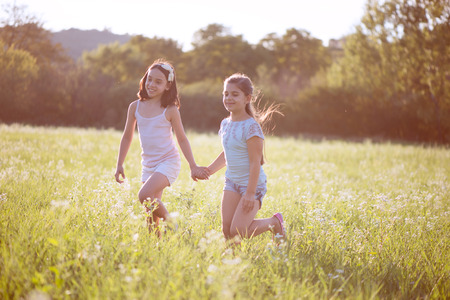 Group of happy children playing on meadowの写真素材