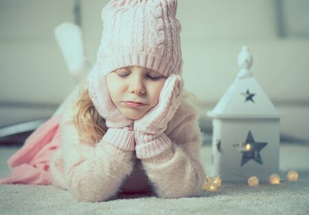 Portrait of ptetty little girl at christmas time with flashlight