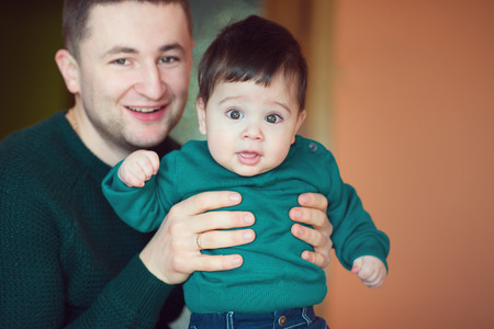 Portrait of loving father with baby boy at homeの写真素材