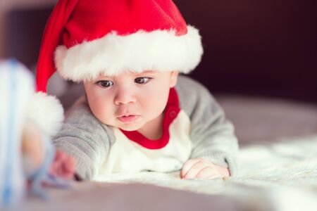 Portrait of cute little baby boy in red  Santa Claus hatの写真素材
