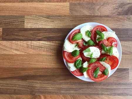 Photo of healthy salad with mozzarella, tomato and green basilの写真素材