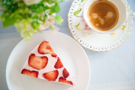 Fresh cheesecake with strawberries on a tableの写真素材