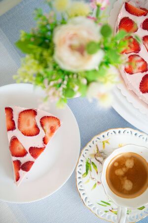Fresh cheesecake with strawberries on a tableの写真素材