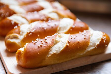 Closeup photo of lye roll bun and bavarian pretzel in bakery