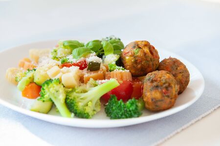 Photo of healthy vegetarian noodles with broccoli cherry tomato and falafelの写真素材