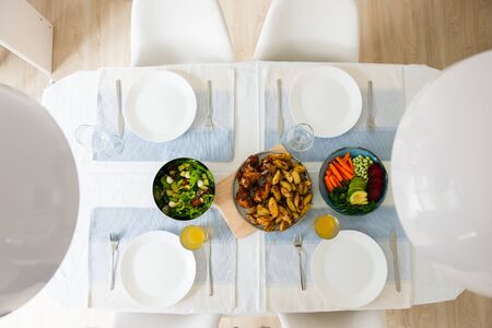 Overview photo of healthy family dinner with baked potato and chicken and salad with avocado, soybeans and colorful vegetablesの写真素材