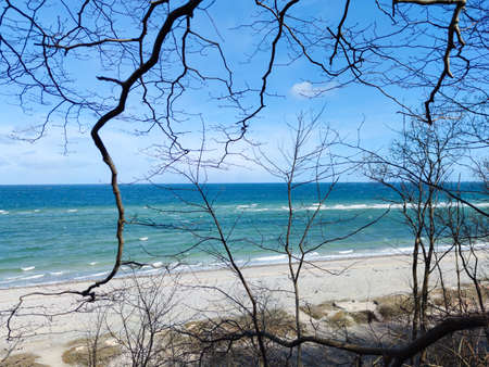Landscape of blue Baltic sea with white sand and cloudy sky in north Germanyの写真素材