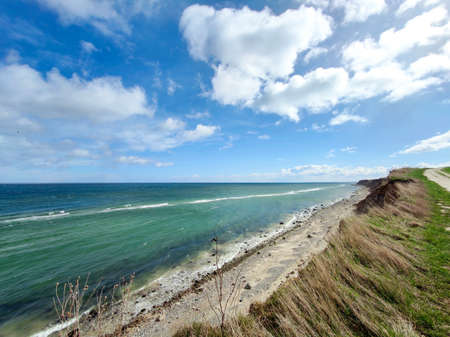 Landscape of blue Baltic sea with white sand and cloudy sky in north Germanyの写真素材