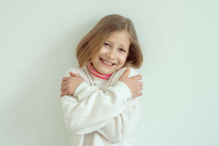 Scared pretty teen girl crossed her hand with panic face on white backgroundの写真素材