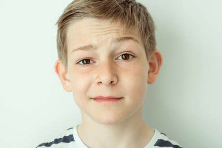 Close up portrait of hansome confused teenager boyの写真素材