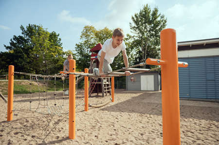 Happy teen children playing and having fun together on playground  at sunny dayの写真素材