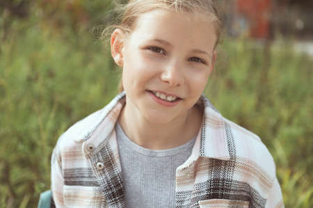 Close up portrait of happy cute little girl after lessonsの写真素材