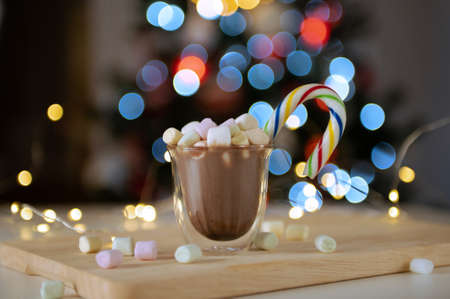 Cup of hot chocolate with colorful marshmallows with bokeh lights on backgroundの写真素材