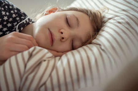 Close up portrait of pretty teen girl sleeping sweet in bed