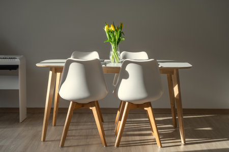Kitchen with white minimalistic interior with fresh flowers in vase on tableの写真素材