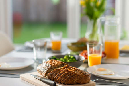 Breakfast closeup with eggs, wholegrain bread, green fresh broccoli, and orange juiceの写真素材