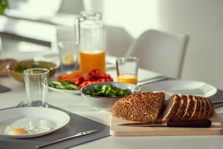 Breakfast closeup with eggs, wholegrain bread, green fresh broccoli, and orange juiceの写真素材