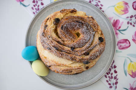Ukrainian traditional easter kulich or paska with blue yellow painted eggs in colours of national...