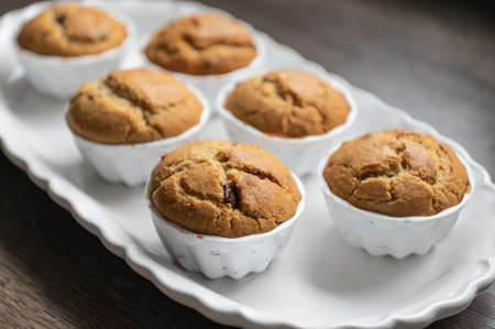 Sweet tasty muffins freshly baked on modern white plateの写真素材