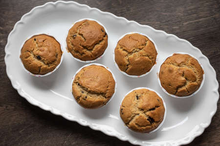 View from above photo of delicious sweet muffins on white plateの写真素材