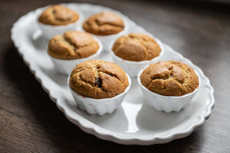 Sweet tasty muffins freshly baked on modern white plateの写真素材