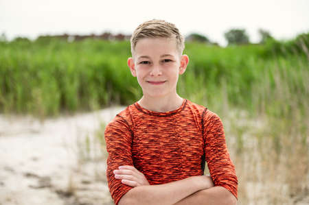 Portrait of handsom teen boy on beautiful white beach at summer holidaysの写真素材